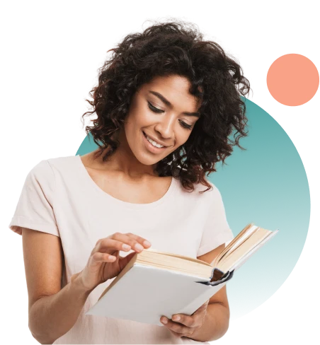 Young woman smiling and reading a book